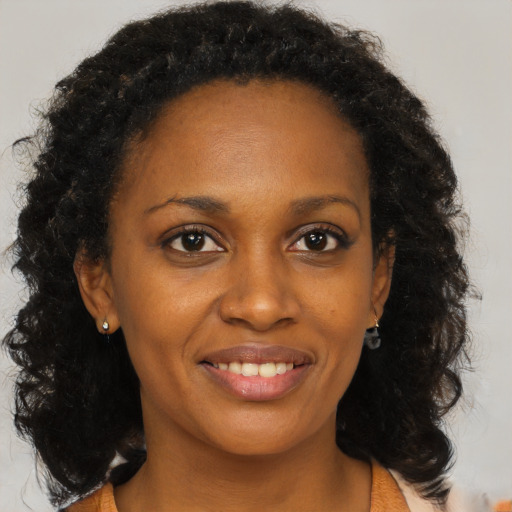 Joyful black young-adult female with medium  brown hair and brown eyes
