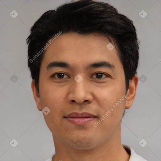 Joyful latino young-adult male with short  black hair and brown eyes