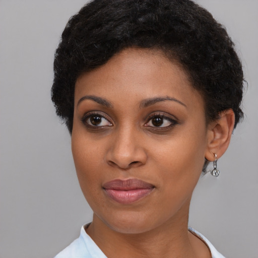 Joyful black young-adult female with short  brown hair and brown eyes