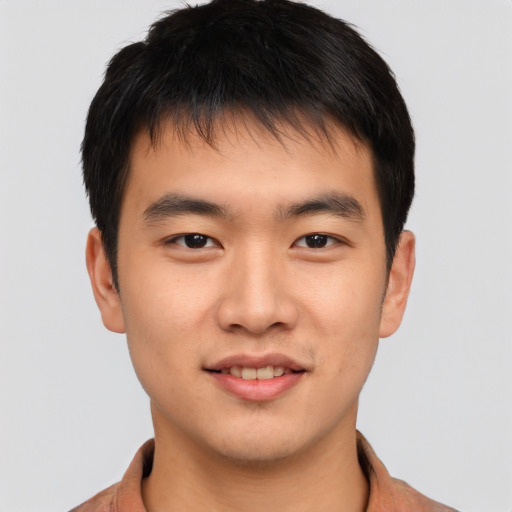 Joyful asian young-adult male with short  brown hair and brown eyes