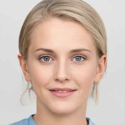 Joyful white young-adult female with medium  brown hair and blue eyes