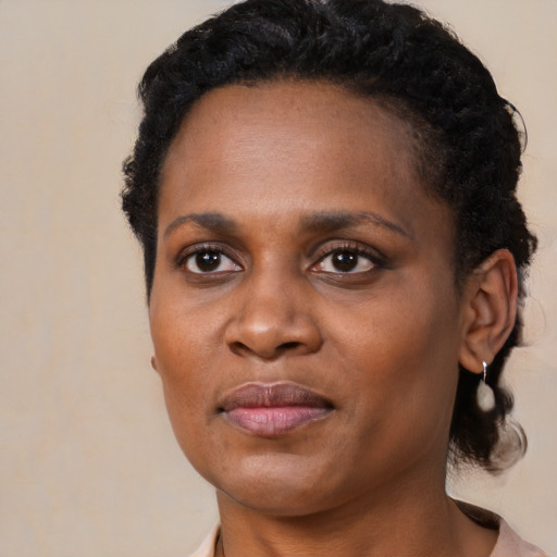Joyful black adult female with short  black hair and brown eyes