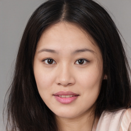 Joyful asian young-adult female with long  brown hair and brown eyes