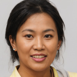 Joyful asian young-adult female with medium  brown hair and brown eyes