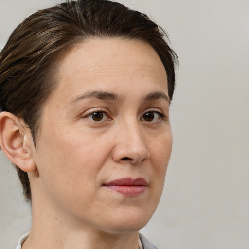 Joyful white adult female with medium  brown hair and brown eyes