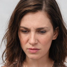 Joyful white adult female with long  brown hair and brown eyes