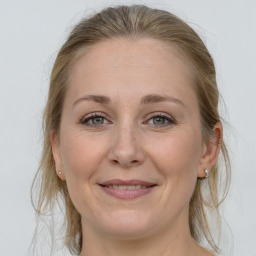 Joyful white adult female with medium  brown hair and grey eyes