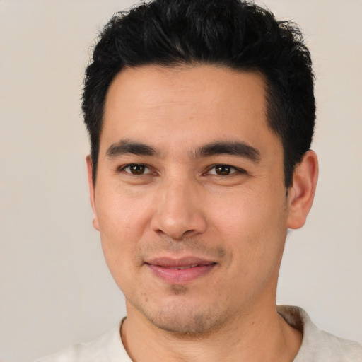 Joyful white young-adult male with short  black hair and brown eyes