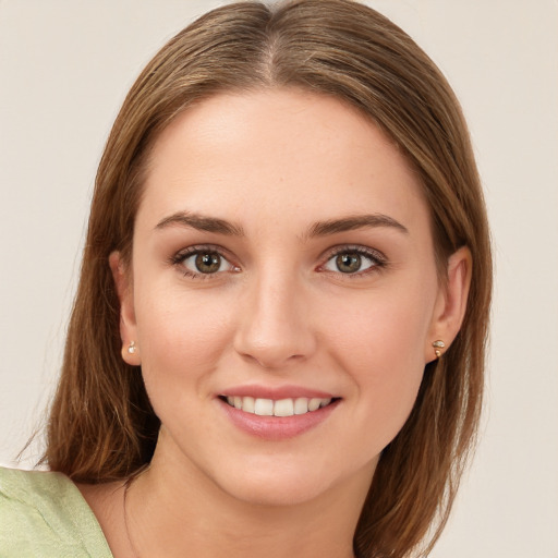 Joyful white young-adult female with medium  brown hair and green eyes