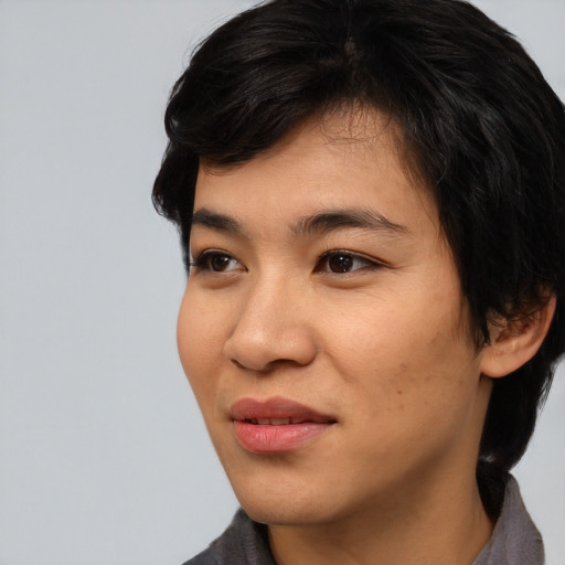Joyful asian young-adult female with medium  black hair and brown eyes