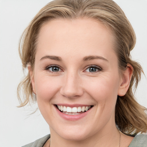 Joyful white young-adult female with medium  brown hair and blue eyes