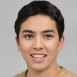 Joyful latino young-adult male with short  brown hair and brown eyes