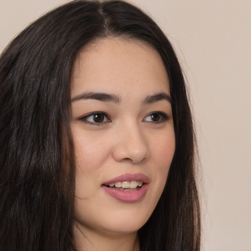 Joyful asian young-adult female with long  brown hair and brown eyes