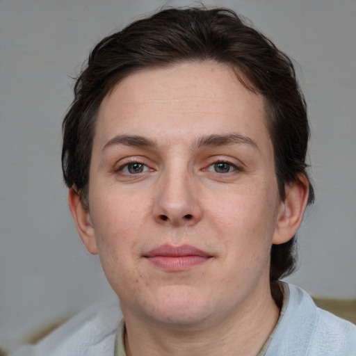 Joyful white adult female with short  brown hair and grey eyes