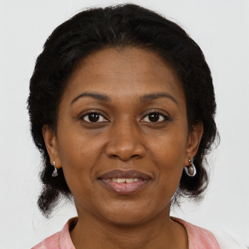 Joyful black adult female with medium  brown hair and brown eyes