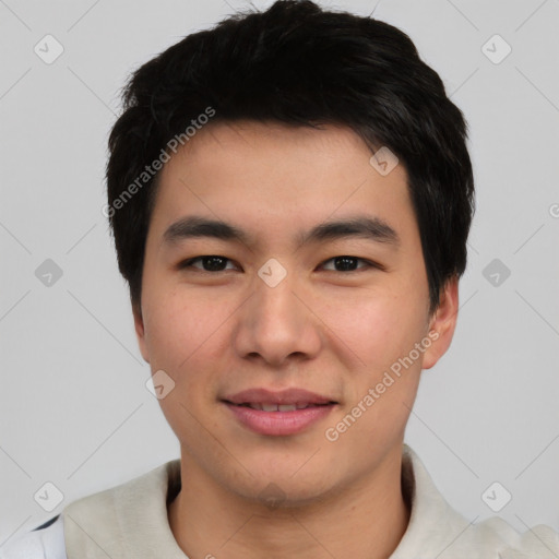 Joyful asian young-adult male with short  black hair and brown eyes