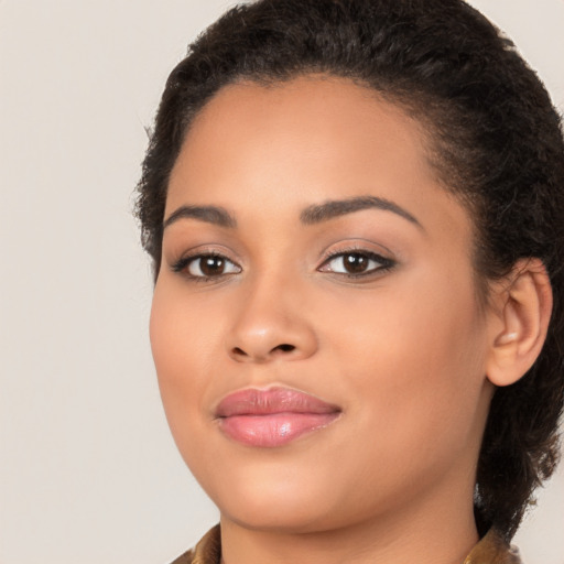 Joyful latino young-adult female with medium  brown hair and brown eyes