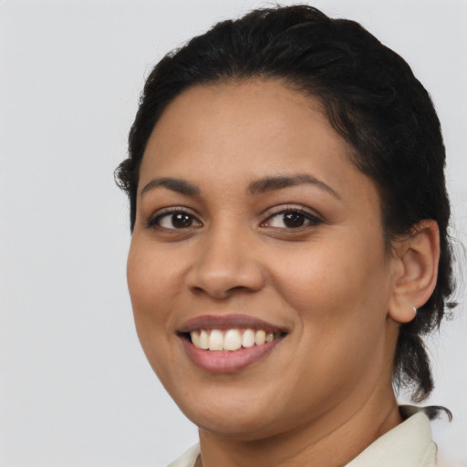 Joyful latino young-adult female with medium  brown hair and brown eyes