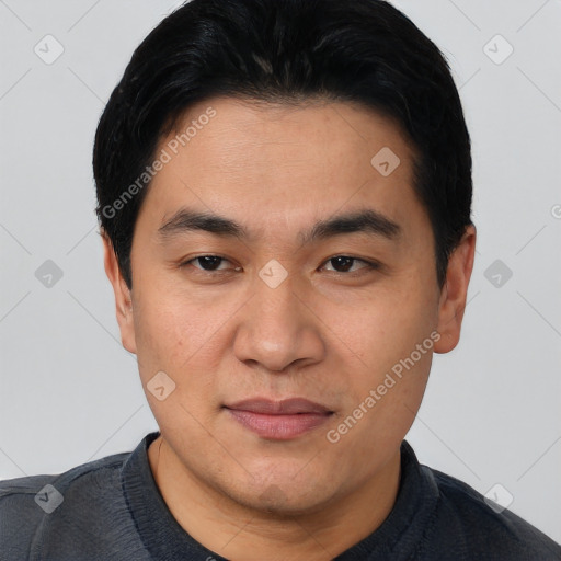 Joyful asian young-adult male with short  black hair and brown eyes