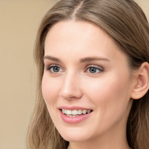 Joyful white young-adult female with long  brown hair and grey eyes