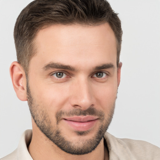 Joyful white young-adult male with short  brown hair and brown eyes