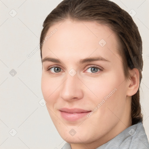 Joyful white young-adult female with medium  brown hair and grey eyes