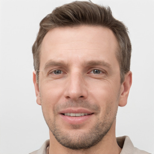 Joyful white adult male with short  brown hair and grey eyes