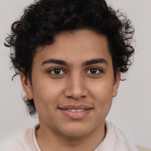 Joyful latino young-adult male with short  brown hair and brown eyes