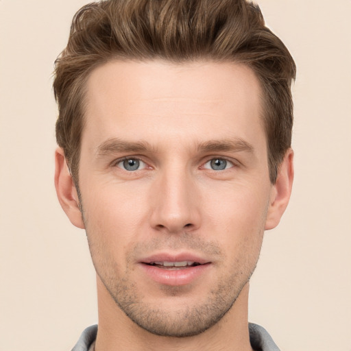 Joyful white young-adult male with short  brown hair and grey eyes