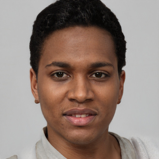 Joyful black young-adult male with short  black hair and brown eyes