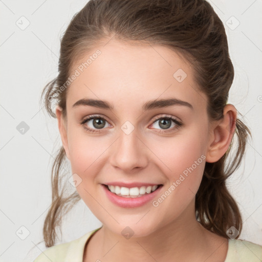 Joyful white young-adult female with medium  brown hair and green eyes