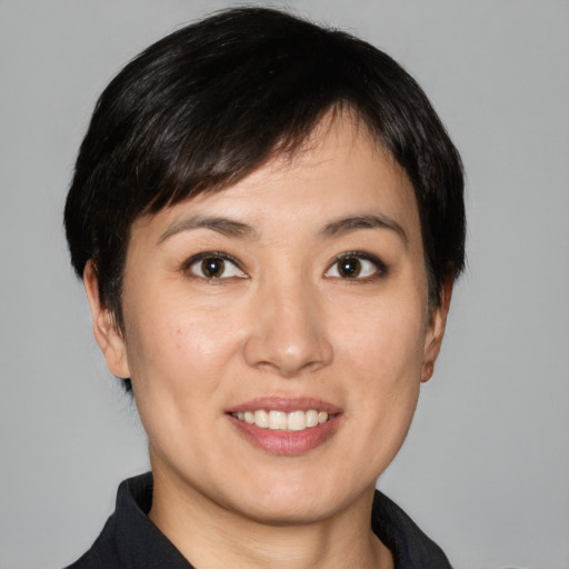 Joyful white young-adult female with short  black hair and brown eyes