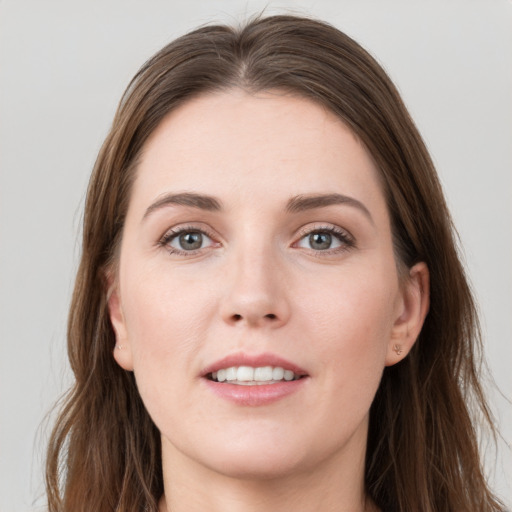 Joyful white young-adult female with long  brown hair and grey eyes