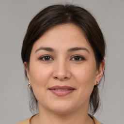 Joyful white young-adult female with medium  brown hair and brown eyes