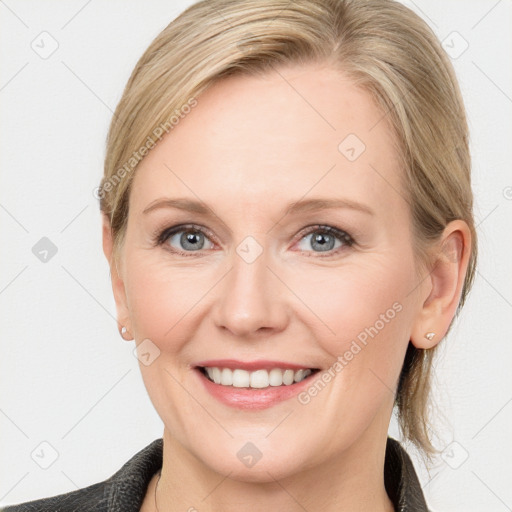 Joyful white young-adult female with medium  brown hair and blue eyes