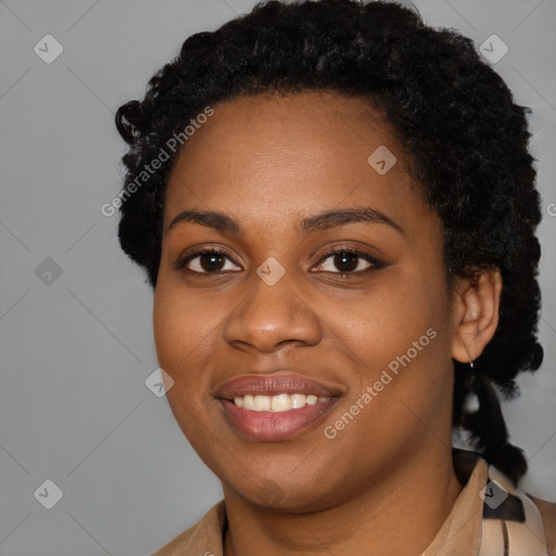 Joyful black young-adult female with long  black hair and brown eyes