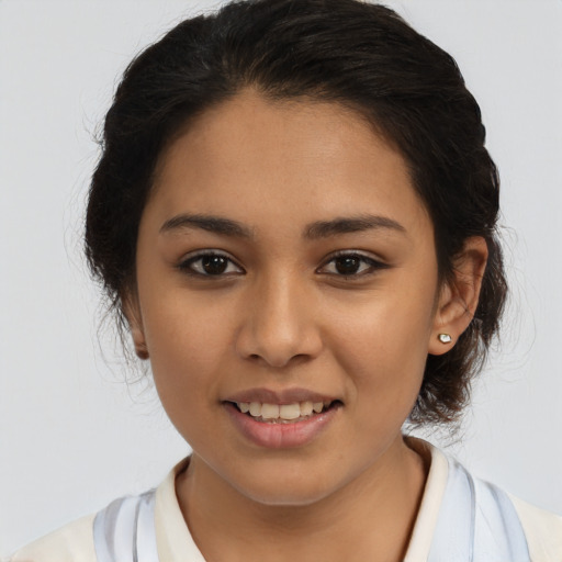 Joyful latino young-adult female with medium  brown hair and brown eyes