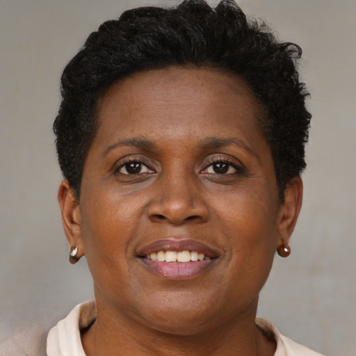 Joyful black adult female with short  brown hair and brown eyes