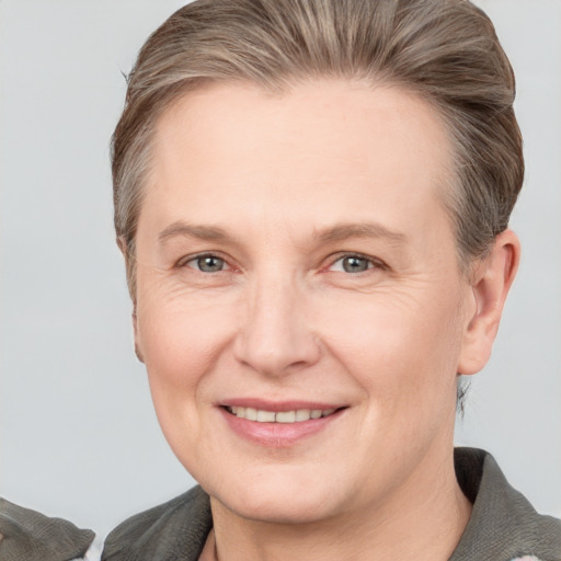 Joyful white adult female with short  brown hair and grey eyes