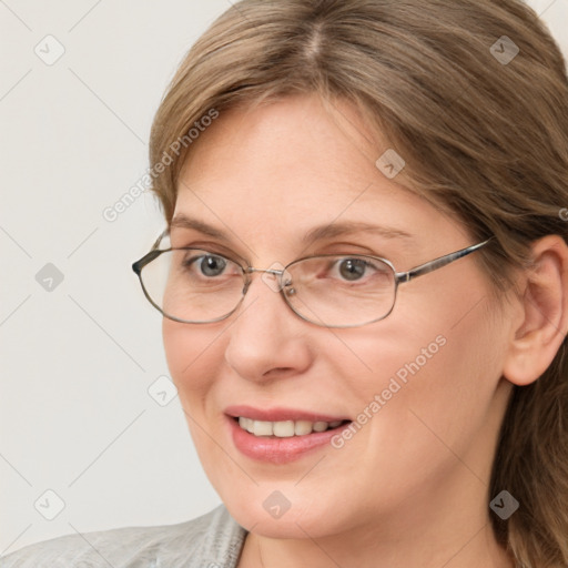 Joyful white adult female with medium  brown hair and blue eyes