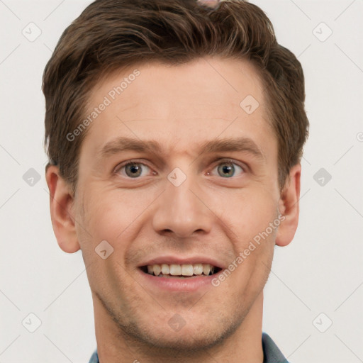 Joyful white young-adult male with short  brown hair and grey eyes