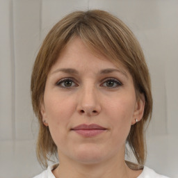 Joyful white adult female with medium  brown hair and brown eyes