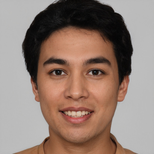 Joyful white young-adult male with short  black hair and brown eyes