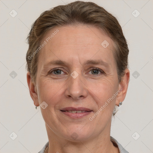 Joyful white adult female with short  brown hair and grey eyes