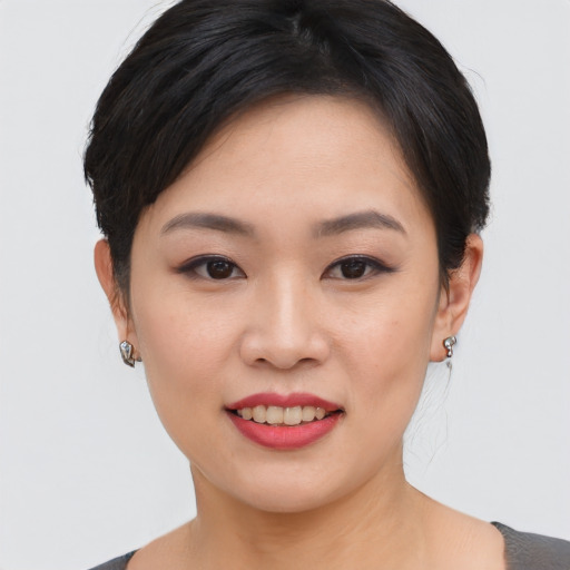 Joyful asian young-adult female with short  black hair and brown eyes