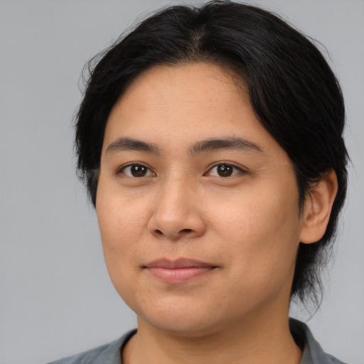 Joyful asian young-adult female with medium  brown hair and brown eyes