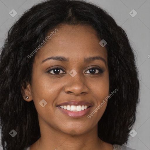 Joyful black young-adult female with long  brown hair and brown eyes