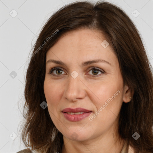 Joyful white adult female with long  brown hair and brown eyes