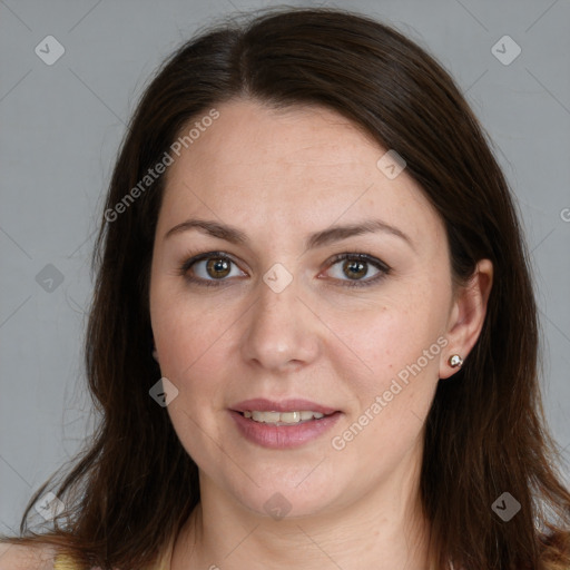 Joyful white adult female with long  brown hair and brown eyes