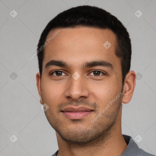 Joyful latino young-adult male with short  black hair and brown eyes